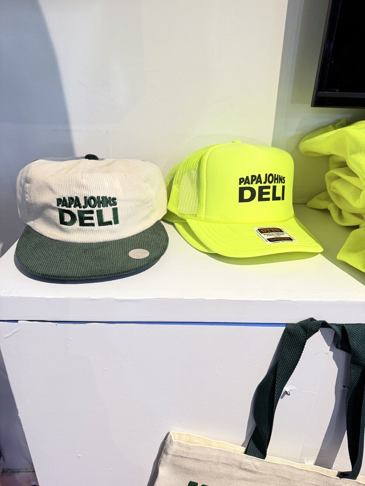 Custom merch display wall with branded pieces hung for browsing