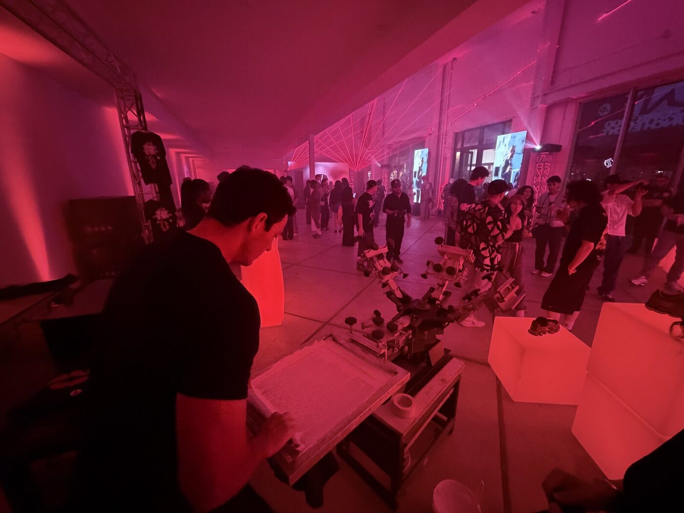 Crowd of guests gathered around a live printing activation